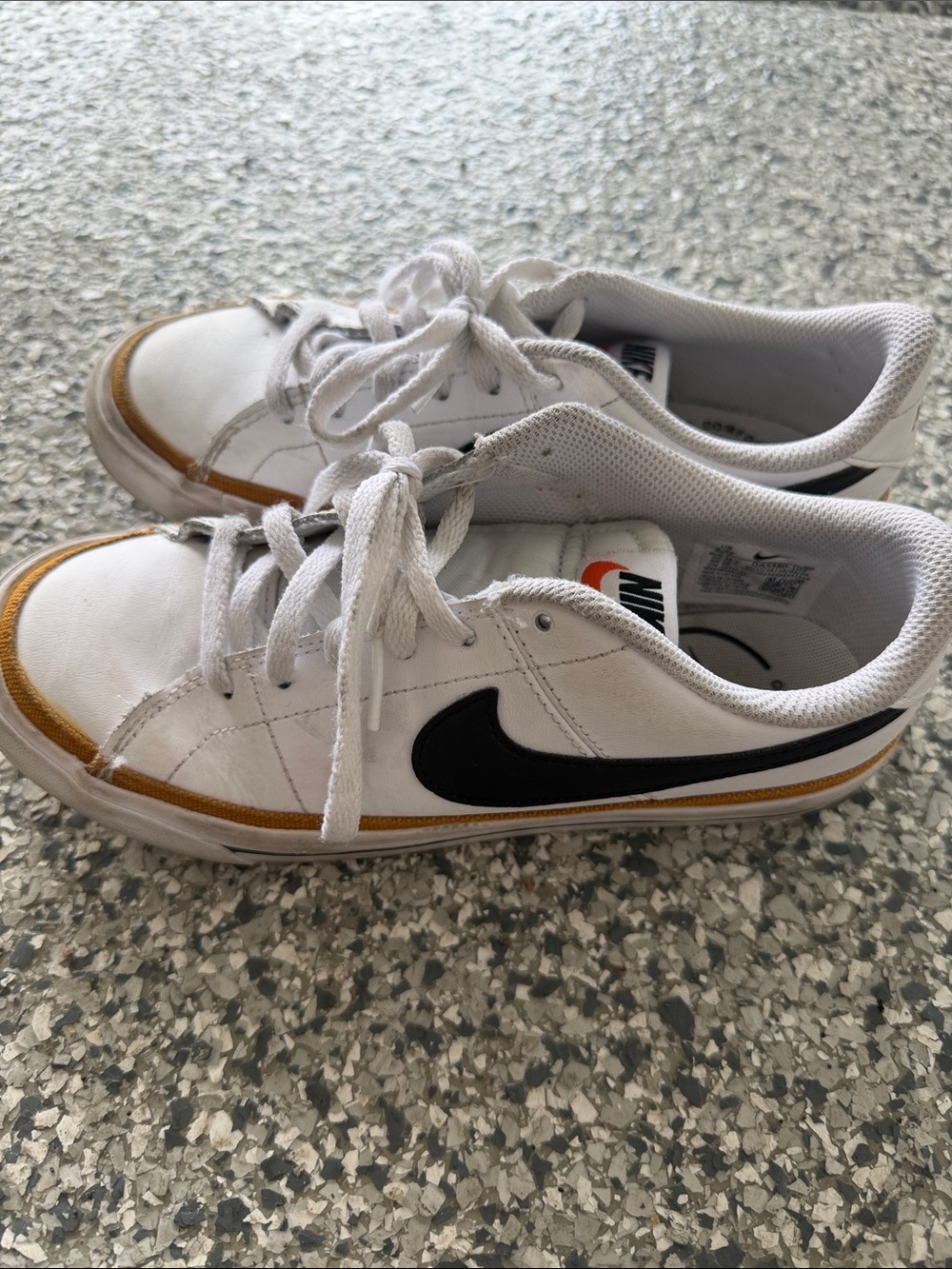 Nike Kids White Low-Top Sneakers with Black Swoosh and Gold Accent